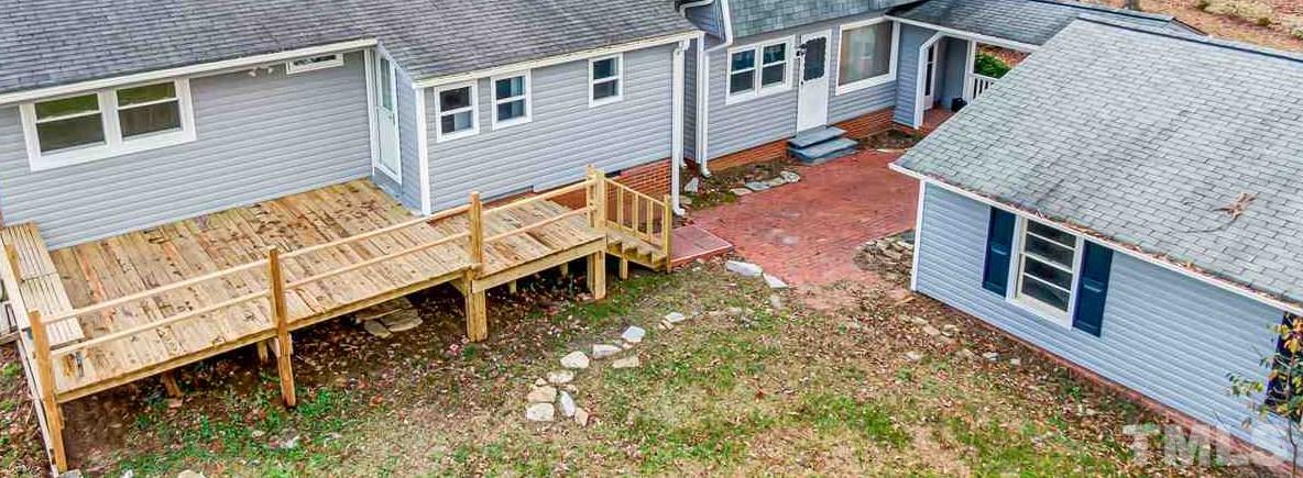 664 Semora Road Roxboro, NC 27573 - Photo 3 of 13 a view of a house with wooden deck
