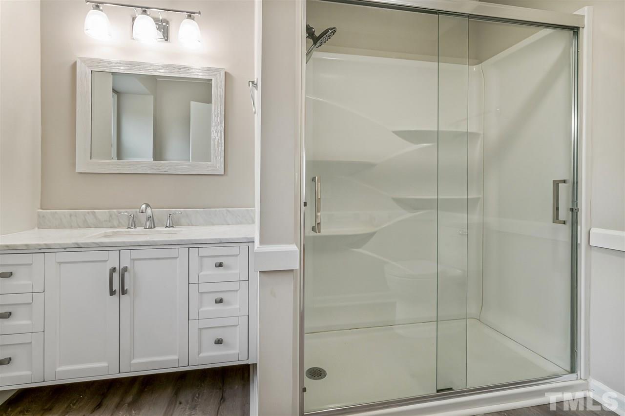 664 Semora Road Roxboro, NC 27573 - Photo 9 of 13 a bathroom with a shower sink and mirror