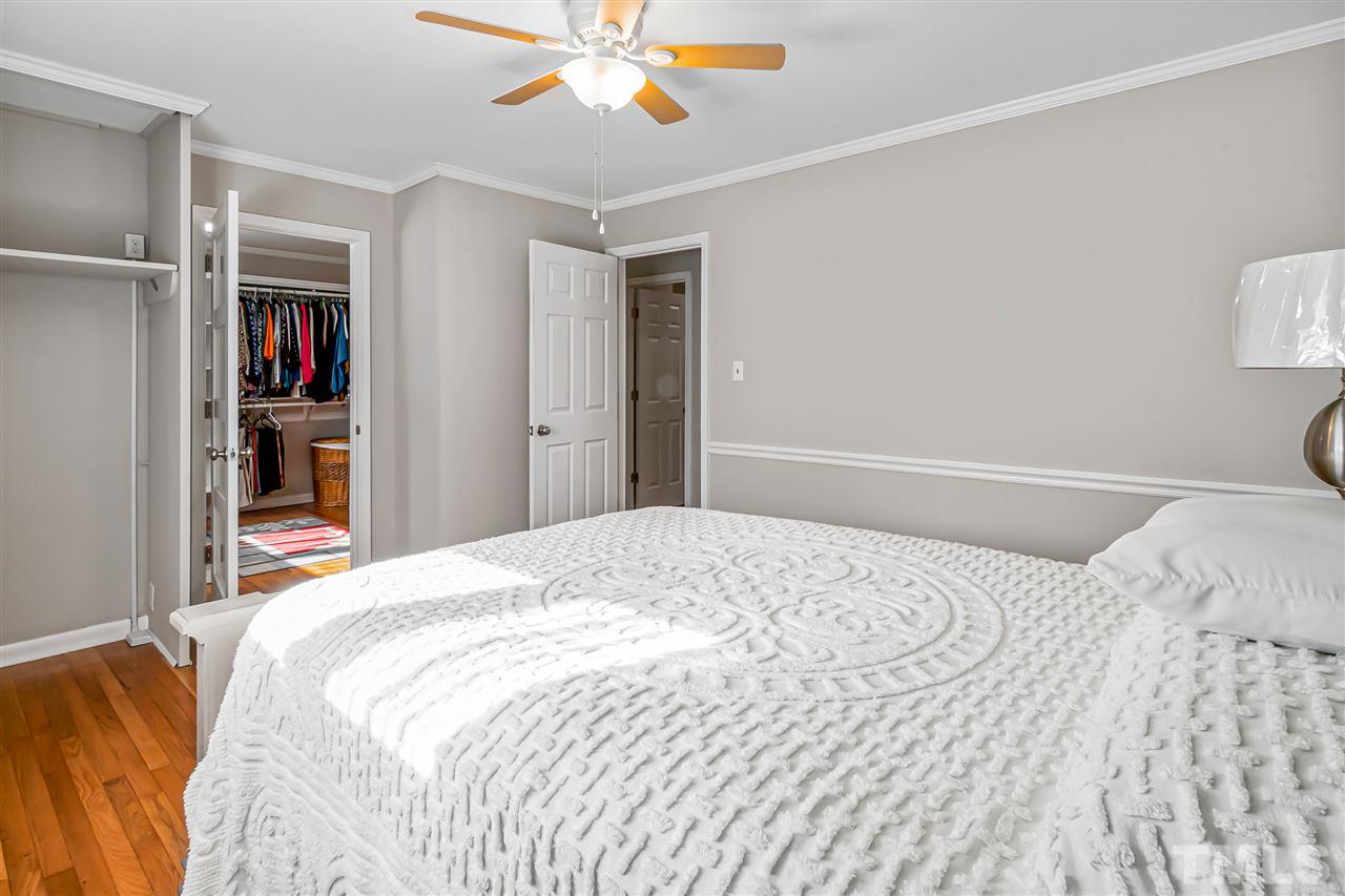 664 Semora Road Roxboro, NC 27573 - Photo 10 of 13 a bedroom with a large bed and a chandelier