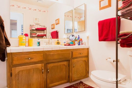 204 North Broadway Street Ridgecrest, CA 93555 - Photo 25 of 29 a bathroom with a sink vanity mirror and toilet