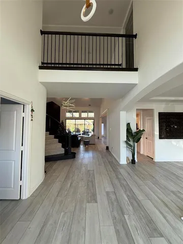 a view of a livingroom with wooden floor and a fireplace