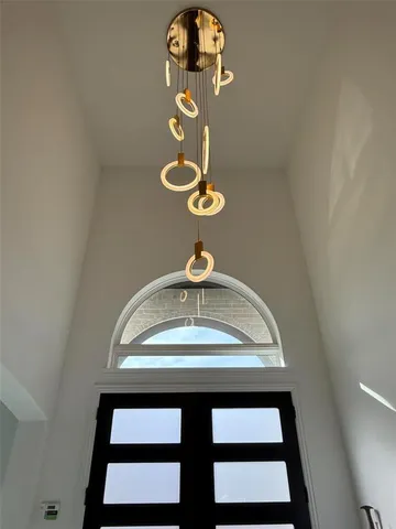 a view of a hallway with a chandelier