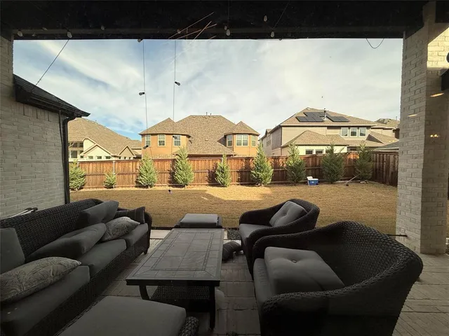 a living room with furniture and a floor to ceiling window