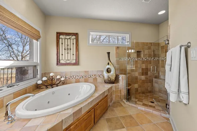 a bathroom with a tub sink and shower