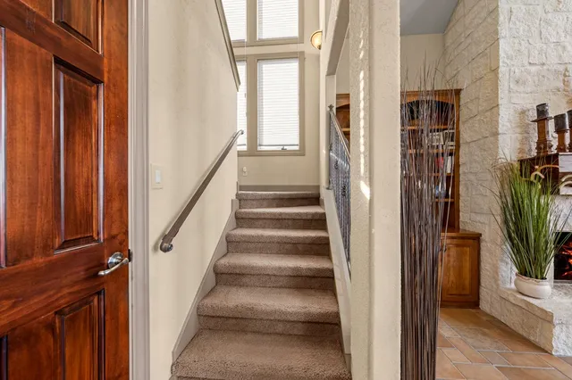 a view of an entryway with wooden floor and stairs