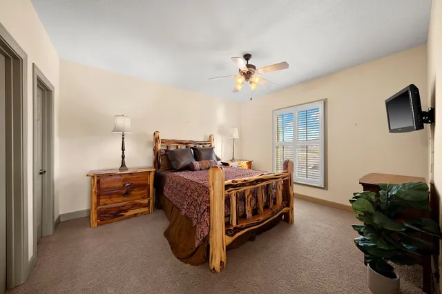 a bed room with a bed furniture and a flat tv screen