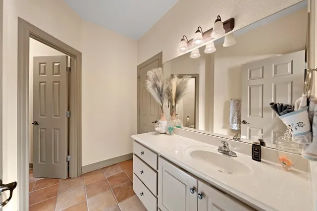 a bathroom with a sink double vanity granite and a mirror