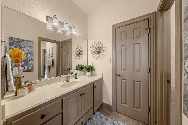 a bathroom with a double vanity sink and a mirror