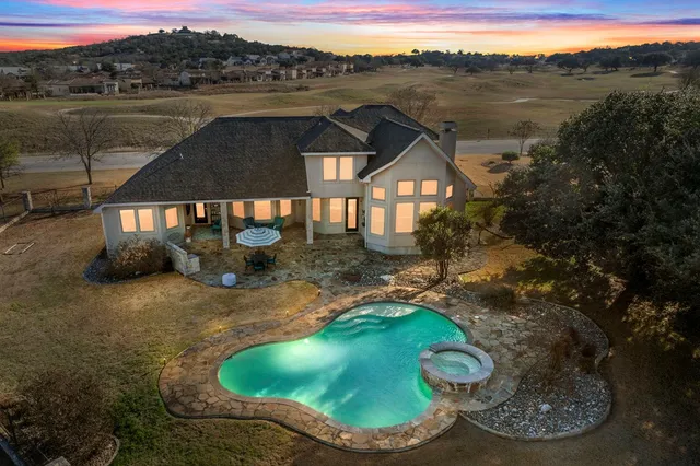 a view of a swimming pool with a yard