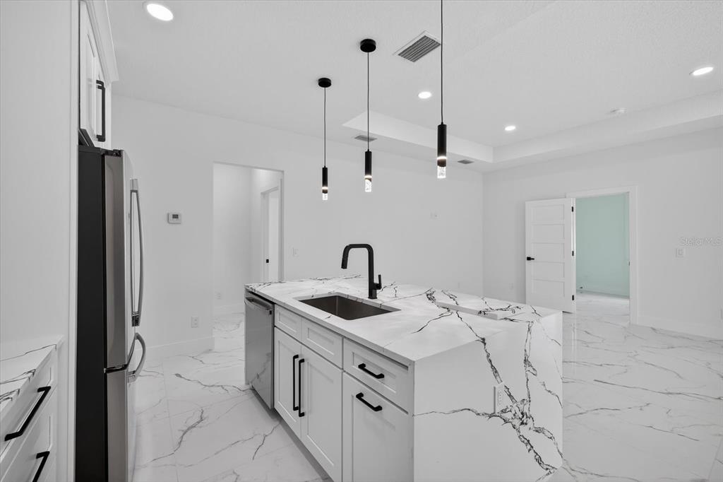 2719 West St John Street Tampa, FL 33607 - Photo 13 of 44 a kitchen that has a sink and a stove