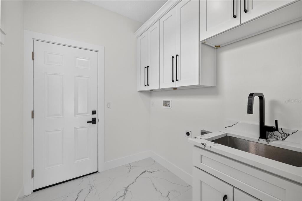 2719 West St John Street Tampa, FL 33607 - Photo 22 of 44 a view of a kitchen with white cabinets