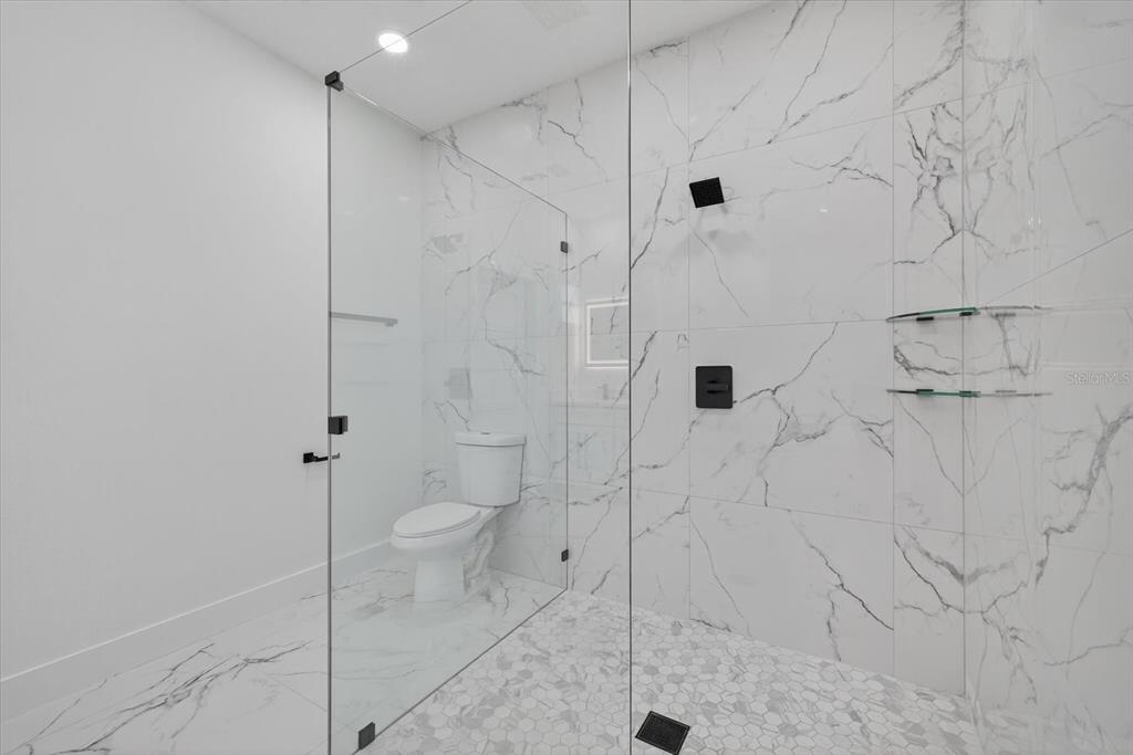 2719 West St John Street Tampa, FL 33607 - Photo 36 of 44 a bathroom with a shower and toilet