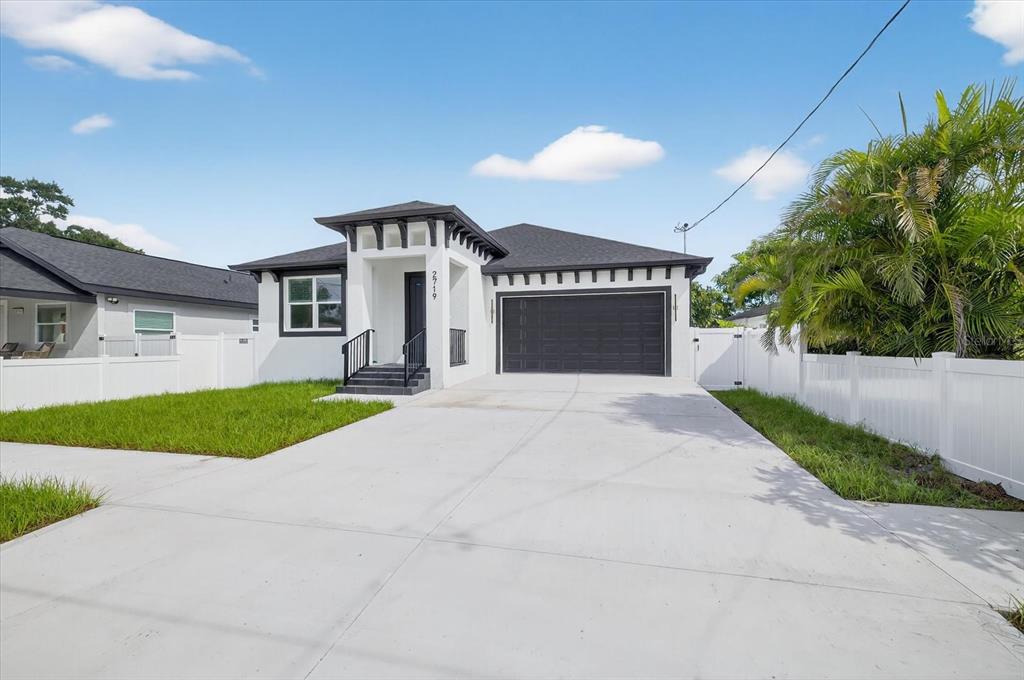 2719 West St John Street Tampa, FL 33607 - Photo 6 of 44 a front view of a house with a yard and garage