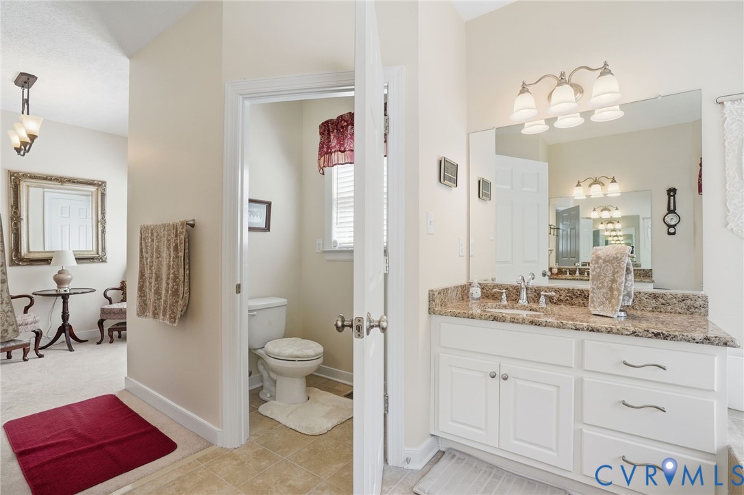 3600 Market Road Mechanicsville, VA 23111 - Photo 33 of 67 a spacious bathroom with a granite countertop sink a toilet a mirror and shower