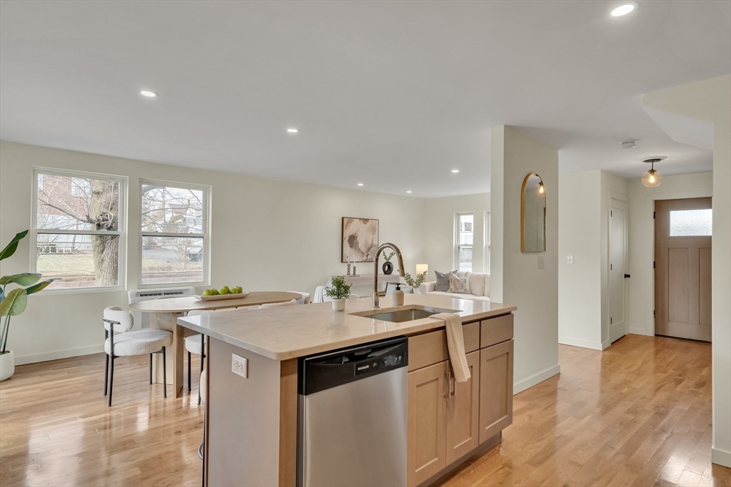 56 Riverview Street Dedham, MA 02026 - Photo 8 of 29 a kitchen with a sink cabinets and wooden floor