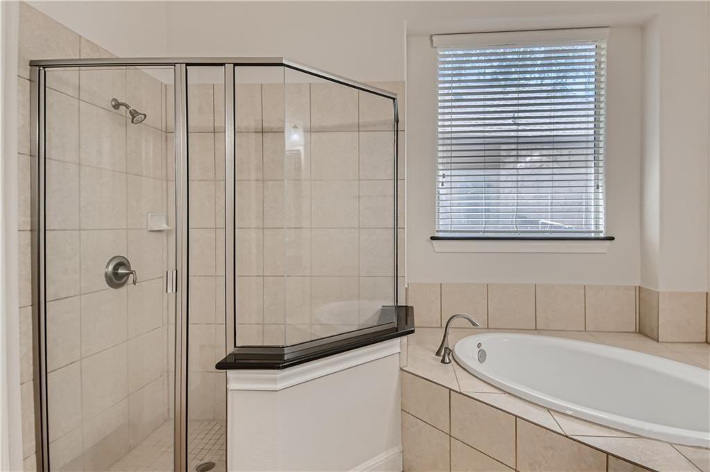 3822 Remington Road Cedar Park, TX 78613 - Photo 19 of 31 a bathroom with a bathtub and a shower