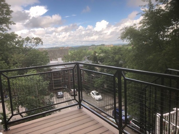 43 Addington Road, Unit 3 Brookline, MA 02445 - Photo 13 of 24 a view of a balcony with wooden floor and fence