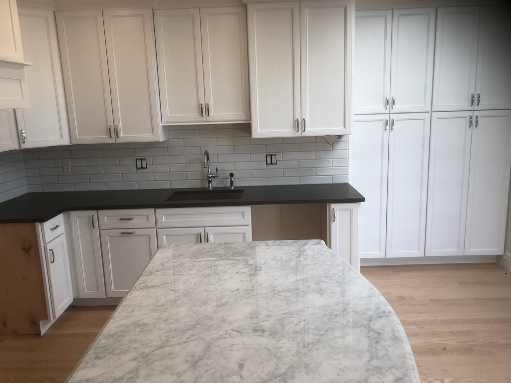 43 Addington Road, Unit 3 Brookline, MA 02445 - Photo 16 of 24 a view of a kitchen with white cabinets