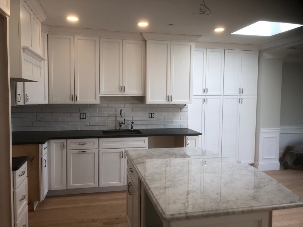 43 Addington Road, Unit 3 Brookline, MA 02445 - Photo 18 of 24 a kitchen with stainless steel appliances granite countertop a sink a stove and a refrigerator