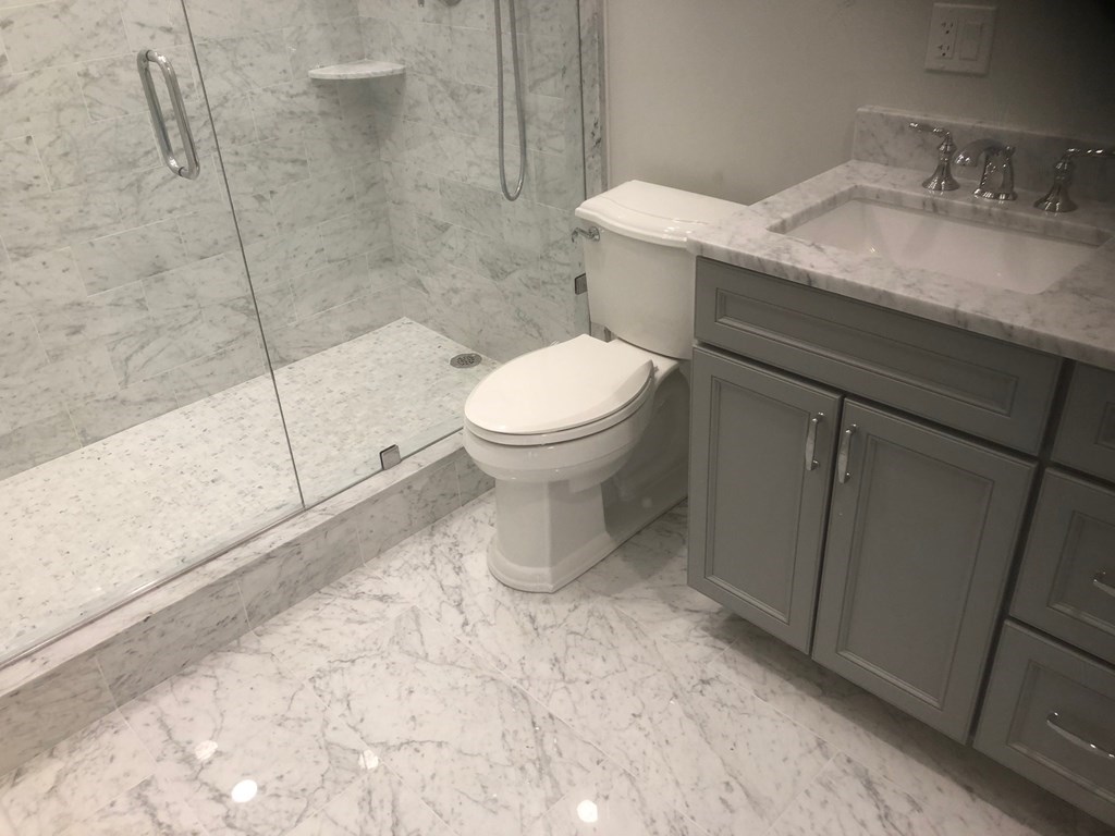 43 Addington Road, Unit 3 Brookline, MA 02445 - Photo 22 of 24 a bathroom with a granite countertop toilet and a sink