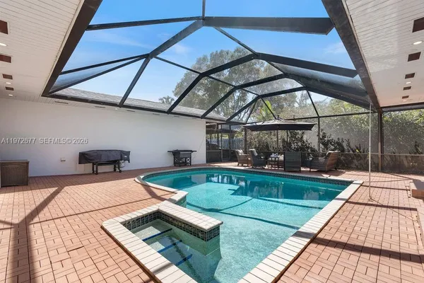 a view of a swimming pool with a patio