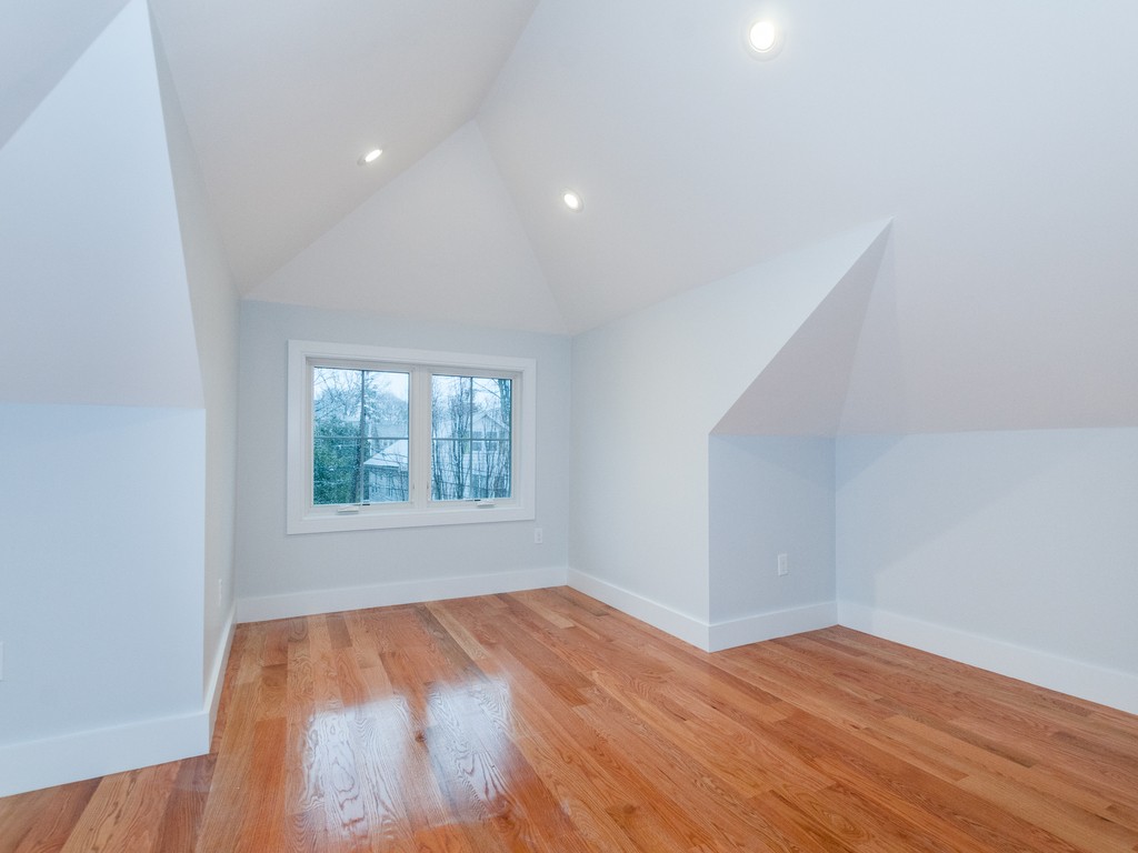 59 Bradford Road, Unit 2 Watertown, MA 02472 - Photo 12 of 20 a view of empty room with wooden floor and fan