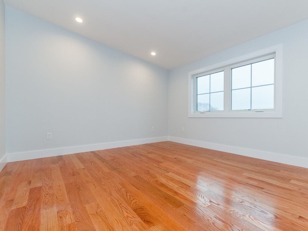 59 Bradford Road, Unit 2 Watertown, MA 02472 - Photo 14 of 20 an empty room with wooden floor and windows
