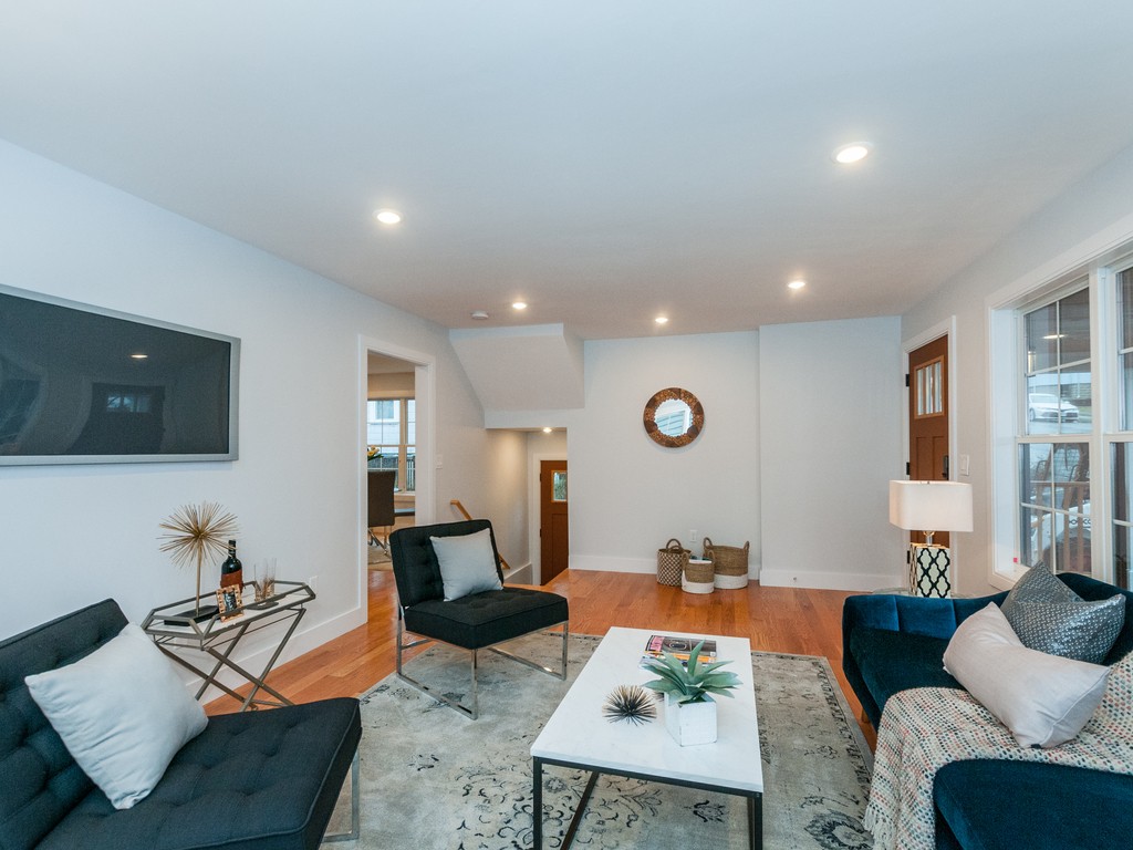 59 Bradford Road, Unit 2 Watertown, MA 02472 - Photo 3 of 20 a living room with furniture and a flat screen tv