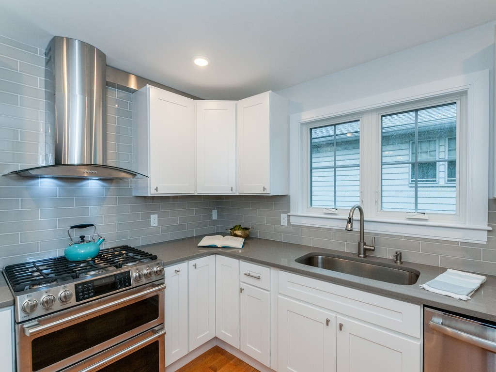 59 Bradford Road, Unit 2 Watertown, MA 02472 - Photo 6 of 20 a kitchen with stainless steel appliances a sink a stove and cabinets