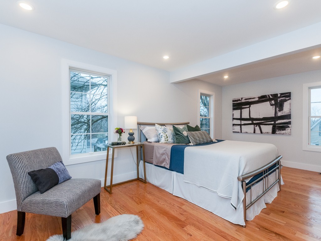 59 Bradford Road, Unit 2 Watertown, MA 02472 - Photo 9 of 20 a bedroom with a bed and a couch
