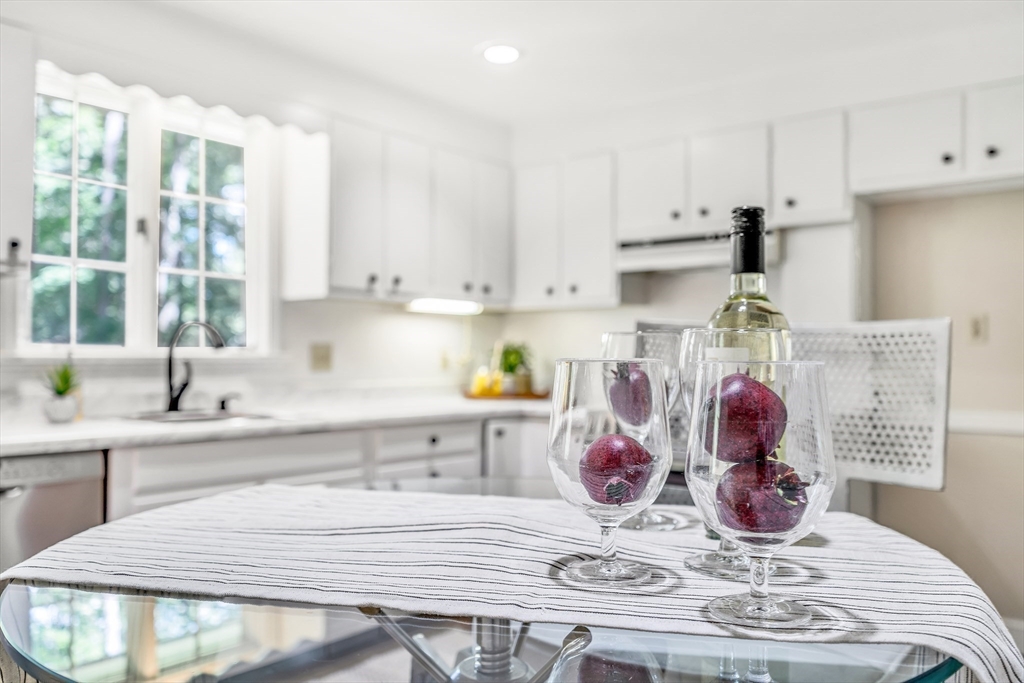 310 Hayward Mill Road Concord, MA 01742 - Photo 13 of 39 a kitchen with kitchen island stainless steel appliances a stove a sink and white cabinets