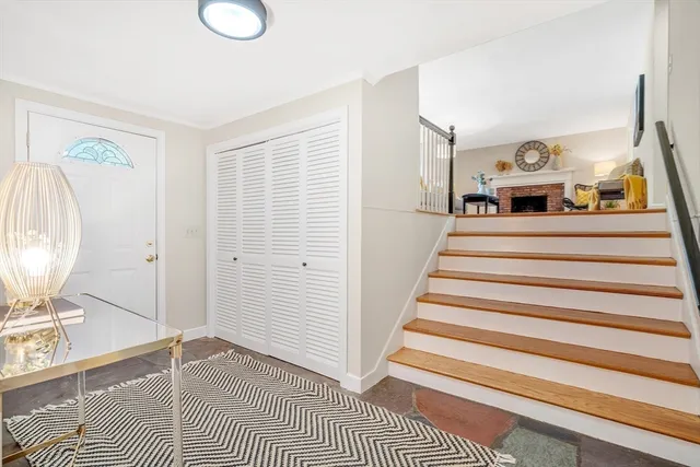 a view of entryway bedroom and hall with wooden floor