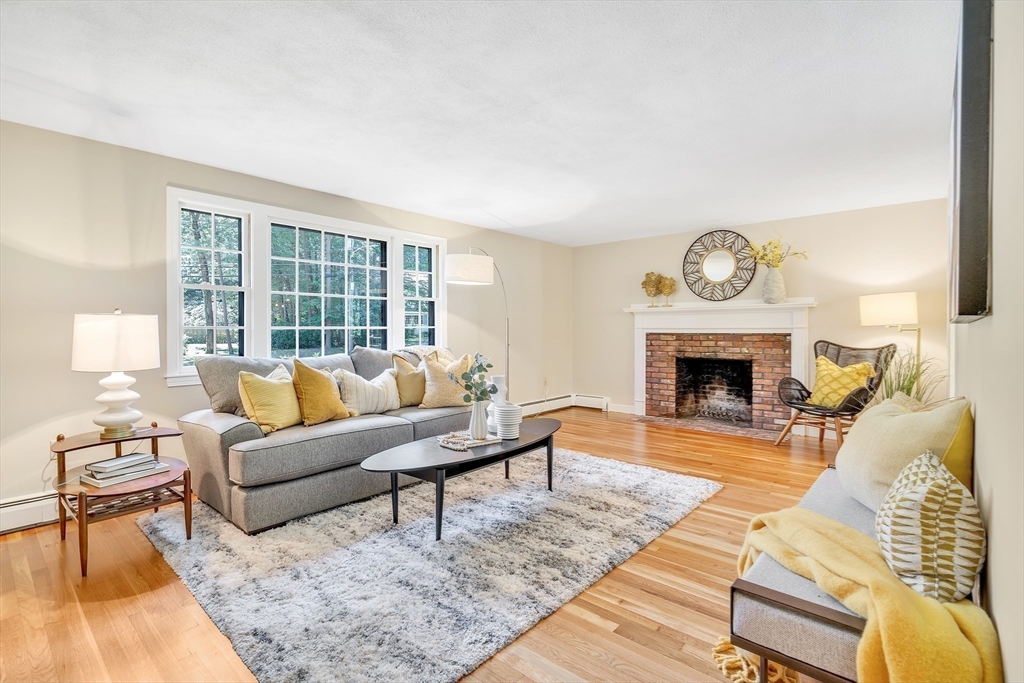 310 Hayward Mill Road Concord, MA 01742 - Photo 2 of 39 a living room with furniture a rug and a fireplace