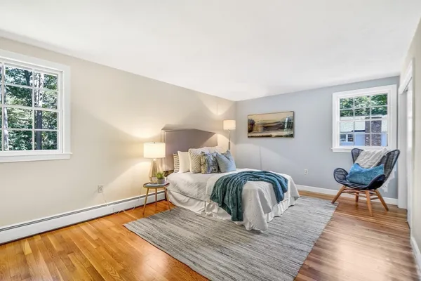 a bedroom with furniture and wooden floor