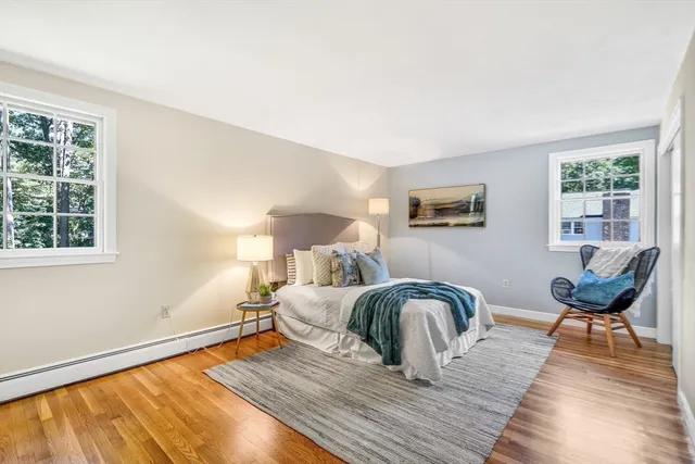 a bedroom with furniture and wooden floor