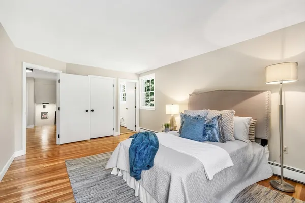 a bedroom with a bed and wooden floor