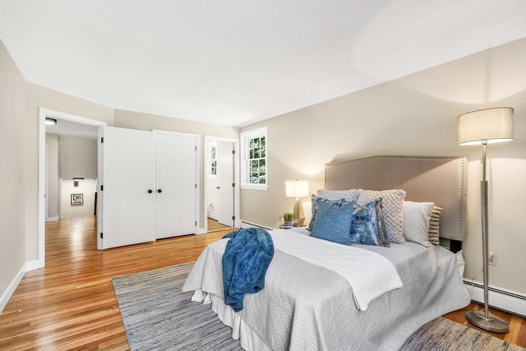 310 Hayward Mill Road Concord, MA 01742 - Photo 24 of 39 a bedroom with a bed and wooden floor