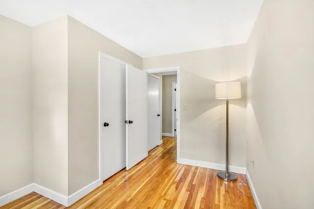 a view of hallway with wooden floor