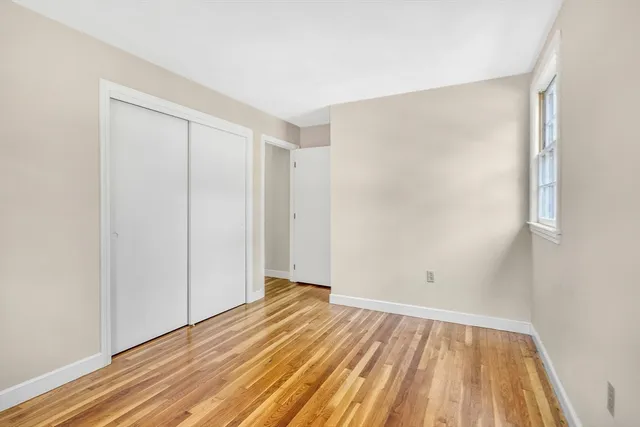 a view of a room with wooden floor
