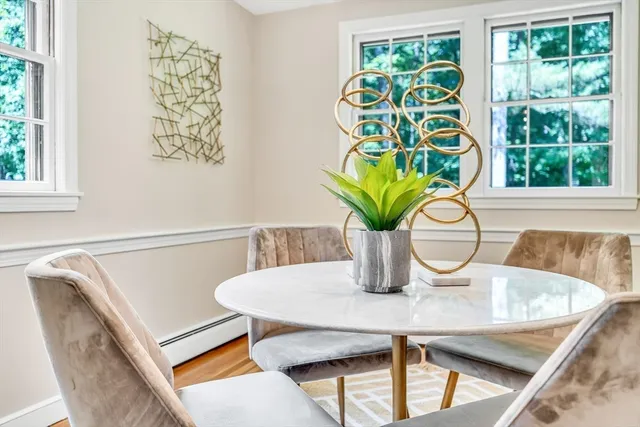 a view of a dining room with furniture and a window
