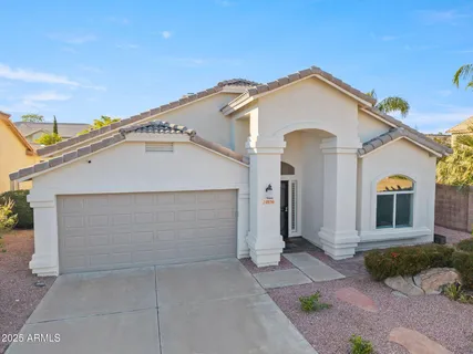a view of a white house with a outdoor space