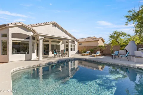 a swimming pool view with plants and large trees