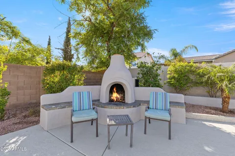a view of house with backyard and outdoor seating