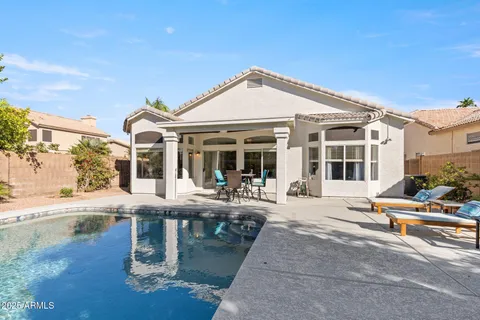 a view of a house with sitting area and garden