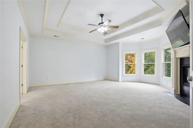 a view of a livingroom with a ceiling fan and window