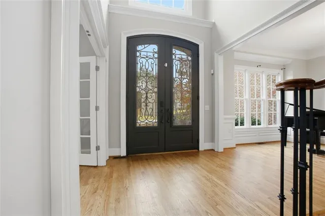 an empty room with wooden floor and a fireplace