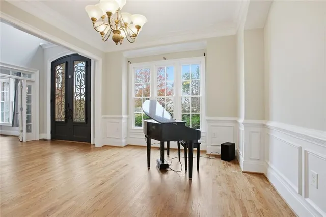 a view of a livingroom with furniture a ceiling fan and wooden floor