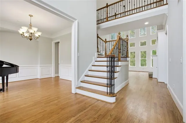 a view of a hallway with wooden floor and staircase