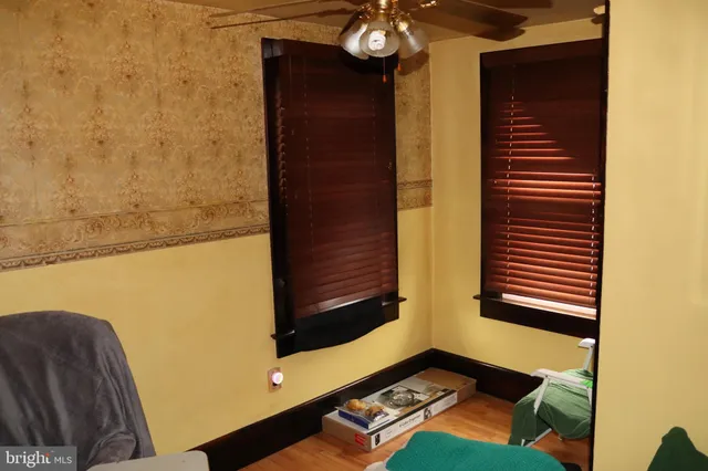 a view of a small space with wooden floor and a window