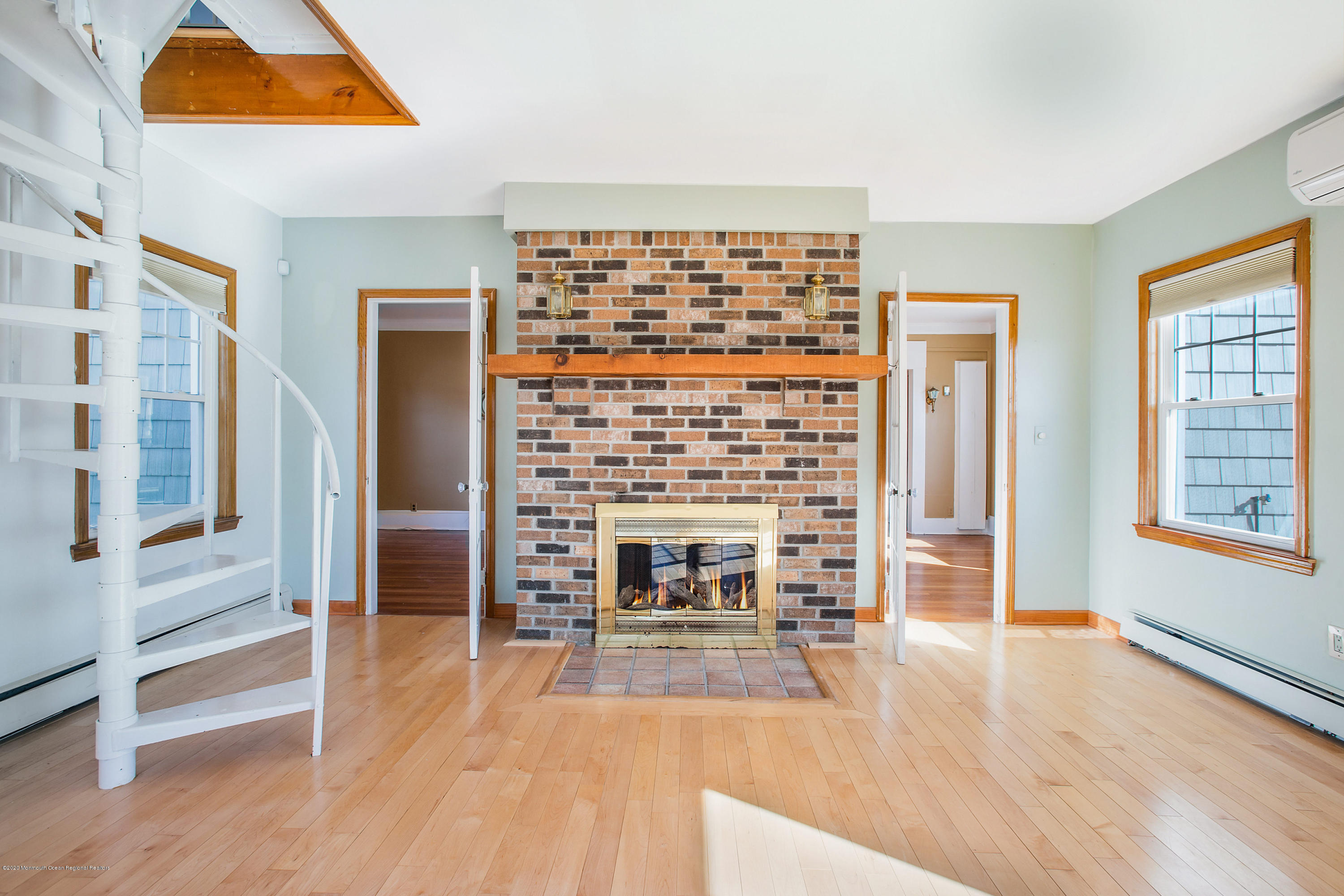 35 Boston Road Neptune City, NJ 07753 - Photo 20 of 30 wooden floor fireplace and windows in a room